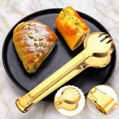 Gold serving utensils detail view